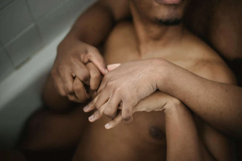 closeup of young shirtless man's hands and arms