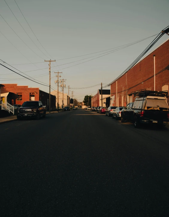 there are cars parked on the street near a building