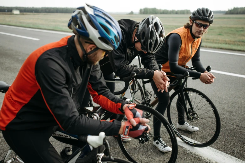 a group of bikers traveling on the road