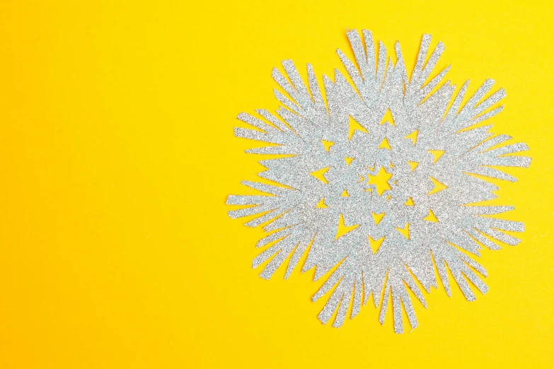 snowflake on a yellow surface with some light