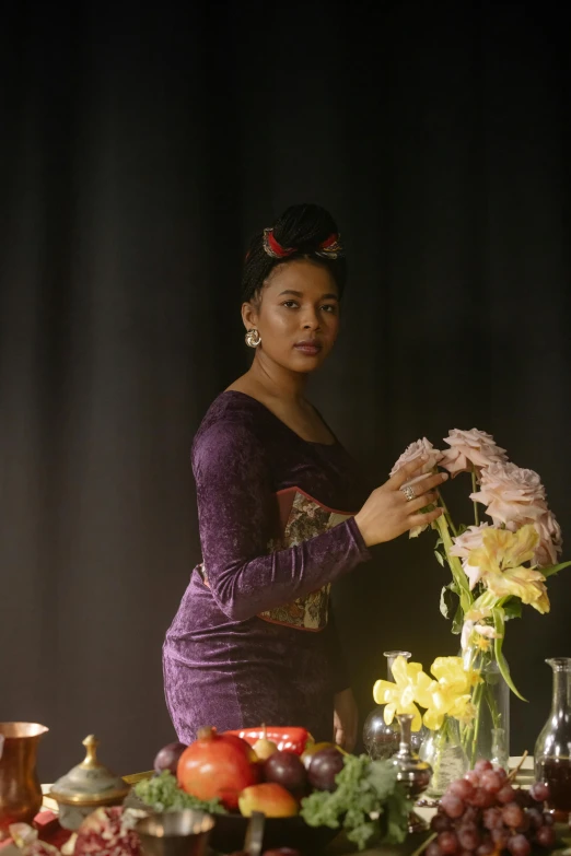 a woman prepares some flowers for a formal dinner