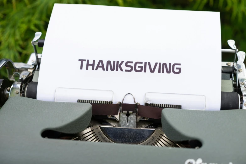 an old typewriter with the words thanksgiving written on it