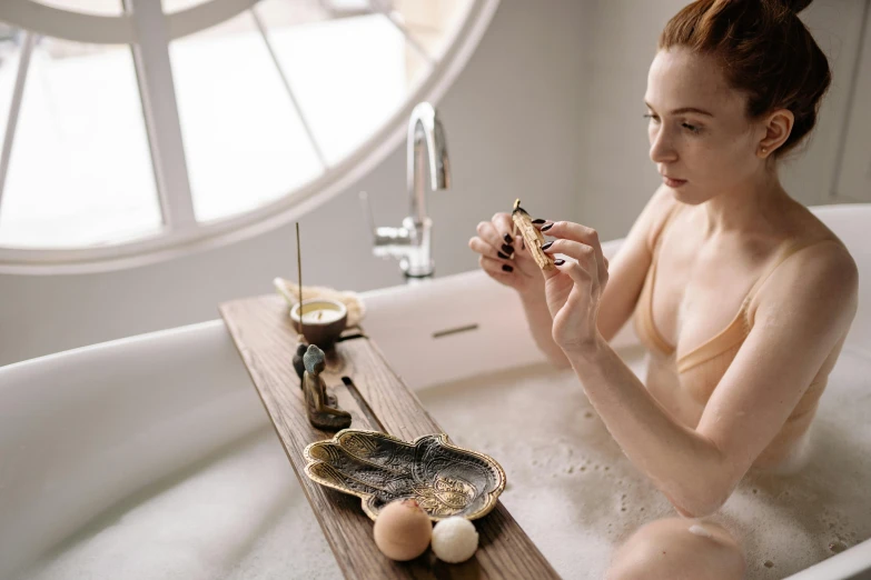 woman in an old fashioned bathroom enjoying her own shower