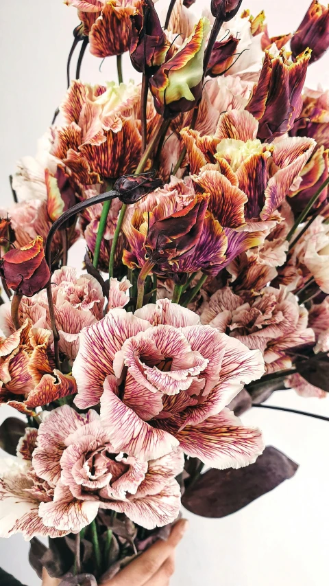 a person holding some very pretty flowers together