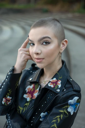 a woman is posing with a shaved head