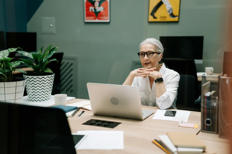 an older woman working on her laptop computer