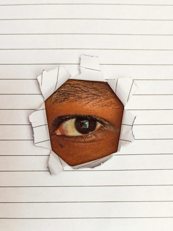 the hand - drawn image of an eye peeking through a hole in paper
