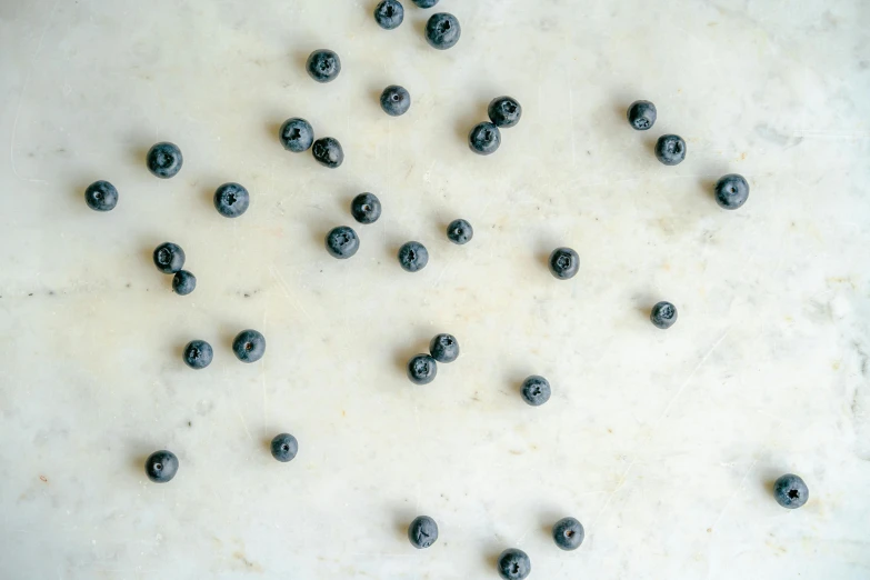 a close up of some blueberries on a surface