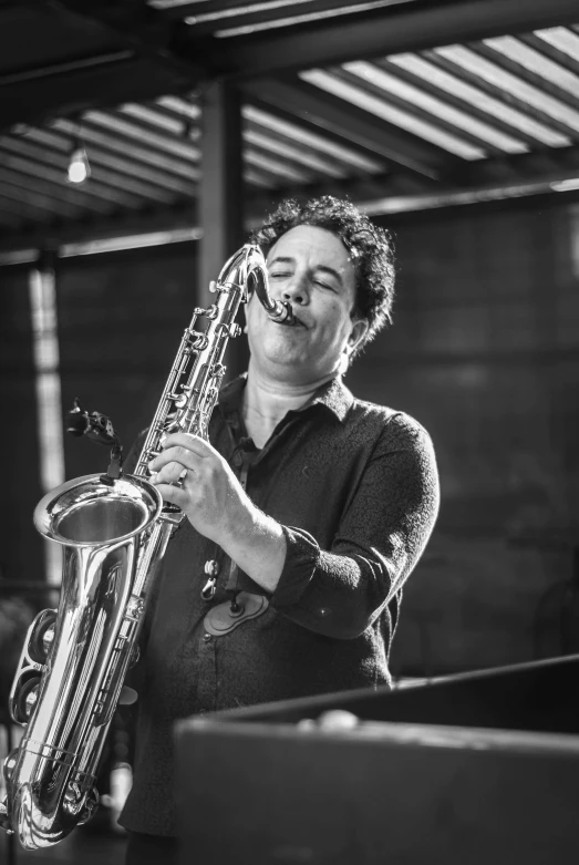 a black and white po of a man playing saxophone