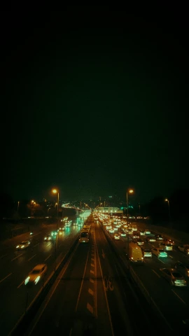 an overhead view of several vehicles traveling on the freeway at night