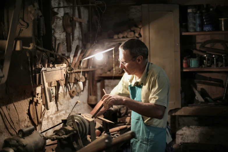 a man working with metal on a spinning mill