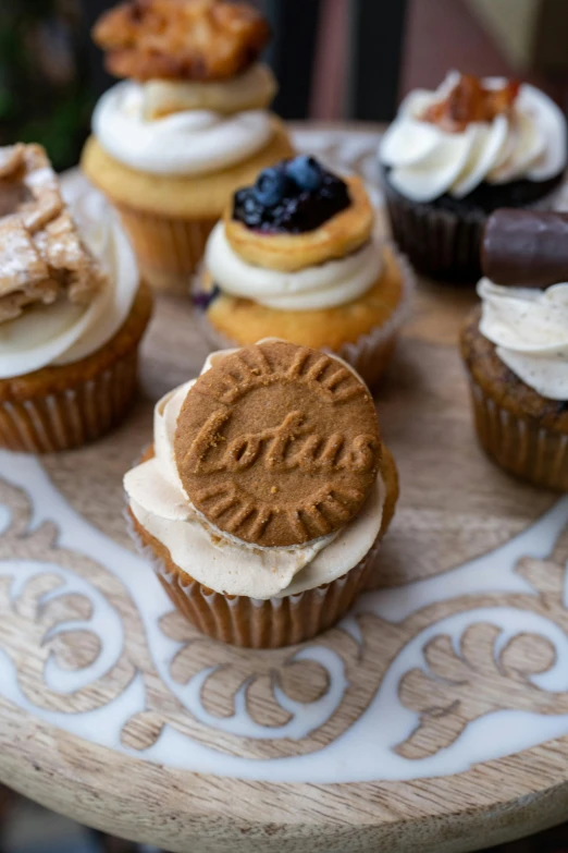 a plate filled with cup cakes and cake toppers