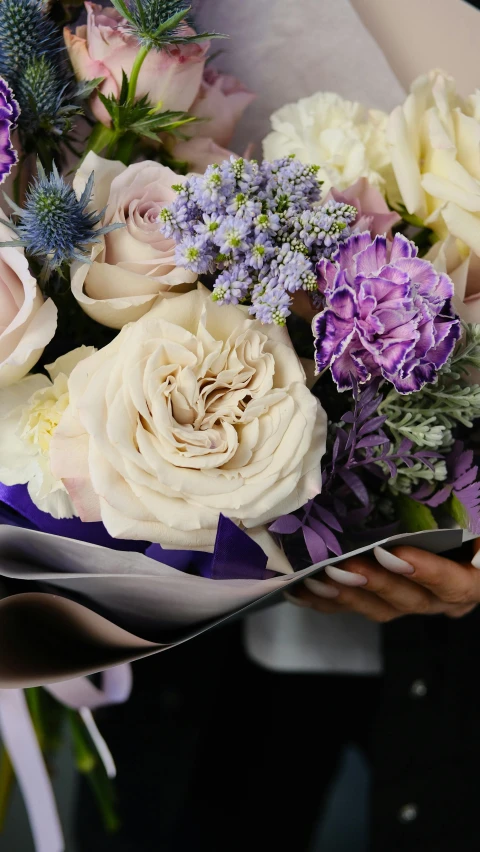 woman holding a bouquet of flowers in her hand