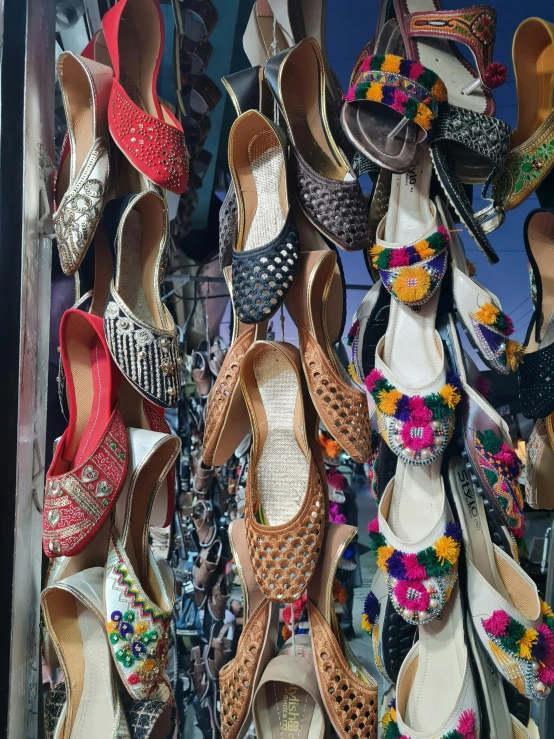 a bunch of sandals hanging in a window