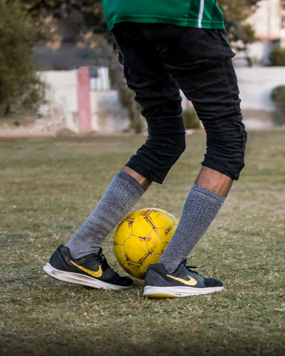 a man standing on top of a soccer ball