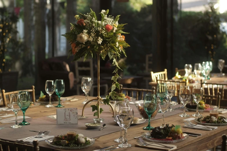 a dining table is set with plates and place settings