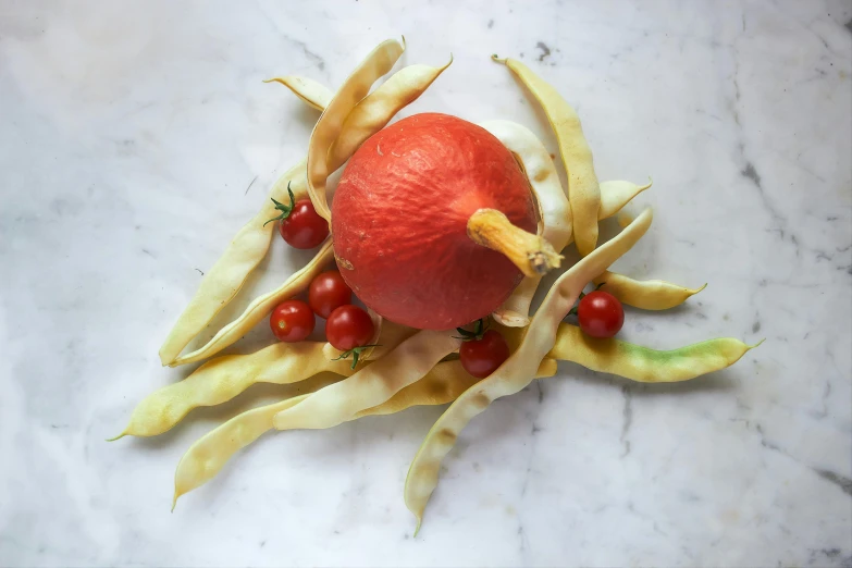 some vegetables on a marble surface are laid on top