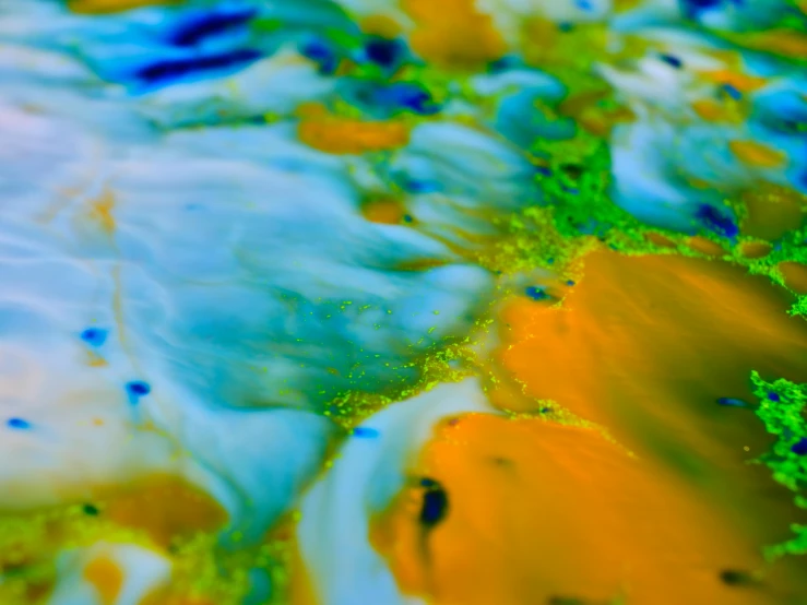 a table topped with lots of paint in yellow and blue