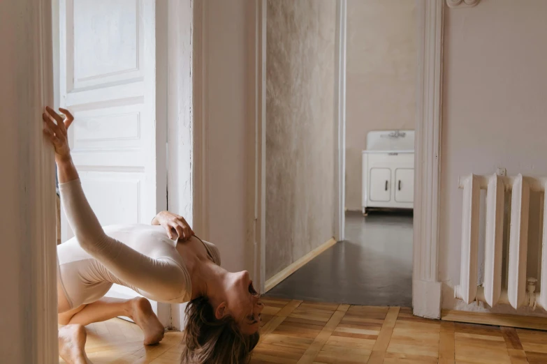 a woman in tight pants doing stretching exercises