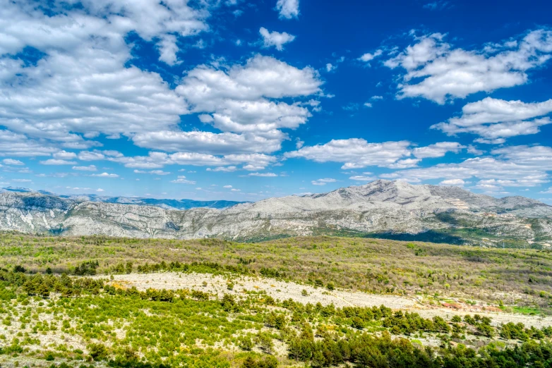 mountains on a sunny day with clouds in the sky