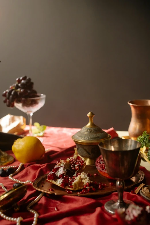 a table with a fancy garnish dish and fruits and vegetables