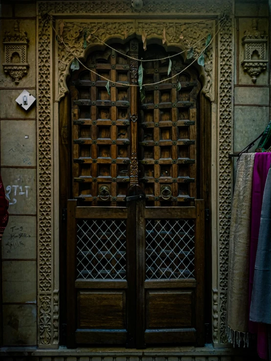 a wooden door with a rope hanging over it