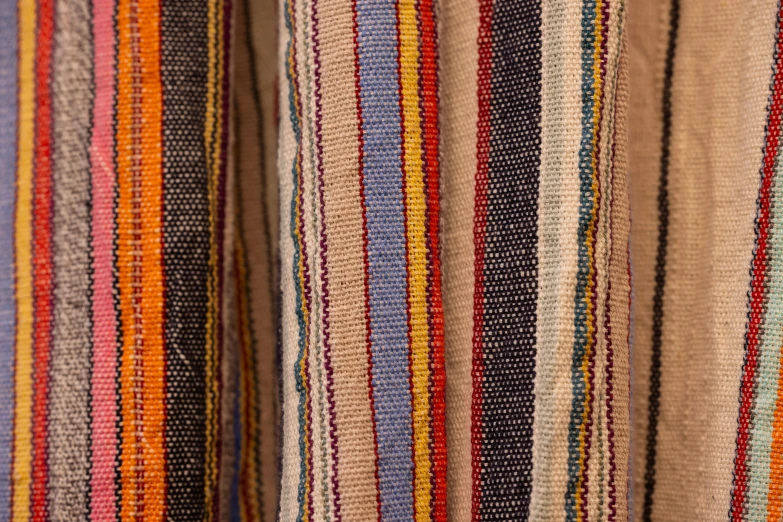 multi - colored strips of cloth are hanging up close