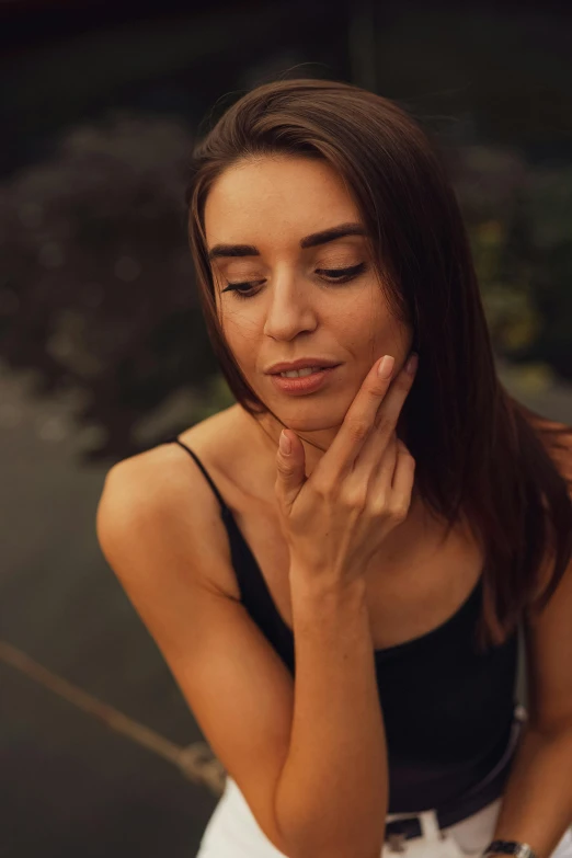 a woman with her eyes closed sitting down