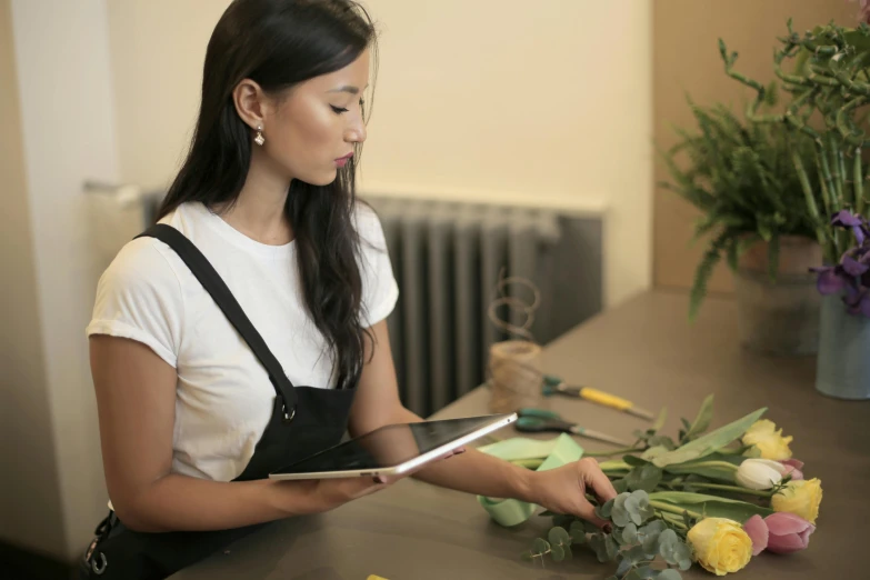 a woman sitting at a counter  a flower