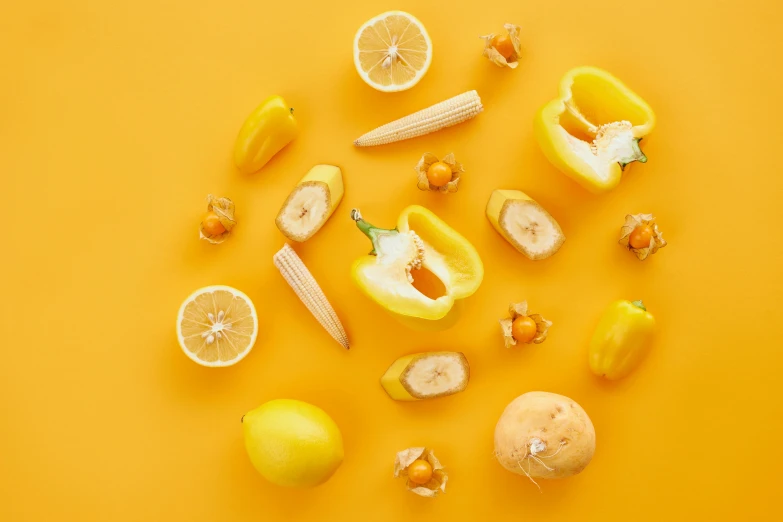 a collection of fruit on a yellow surface