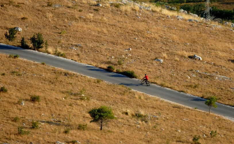 two people are biking up the hill