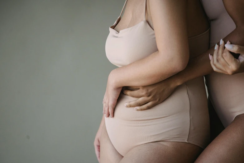 two women wearing beige underwear and s