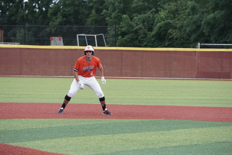 a baseball player waits with his bat ready