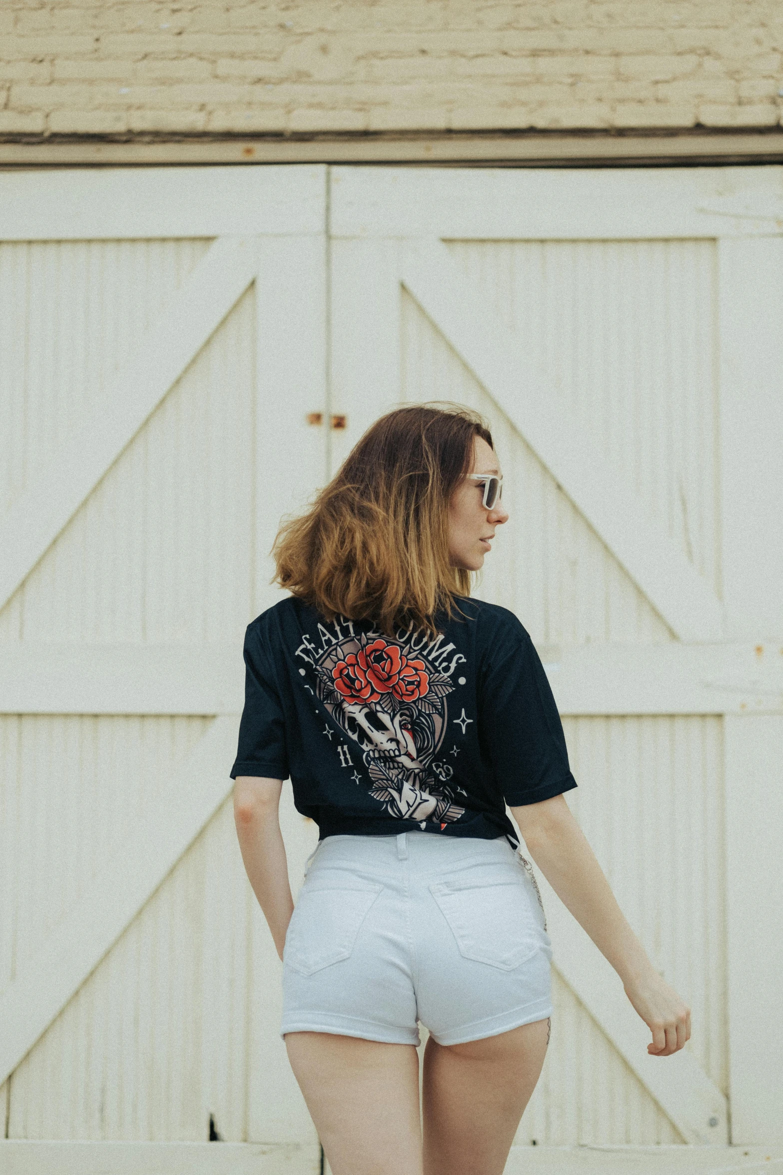 an image of a woman wearing white shorts and a black shirt