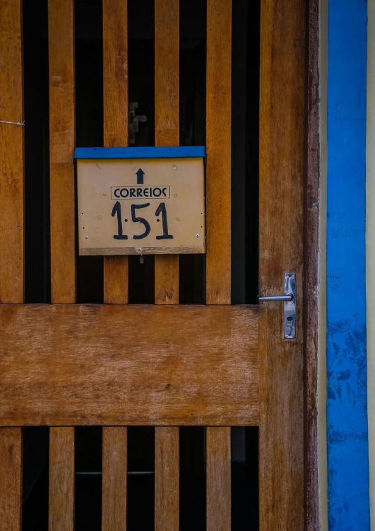 the number 15 is etched into the side of a wooden door