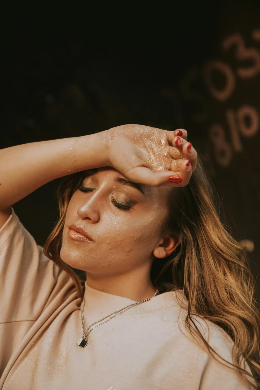 a woman wearing a white top holds her head in the air