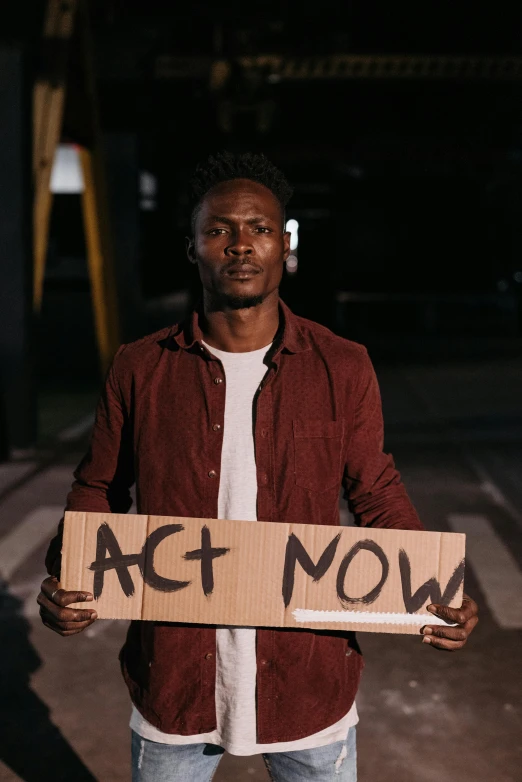 a person holding a sign with words written on it