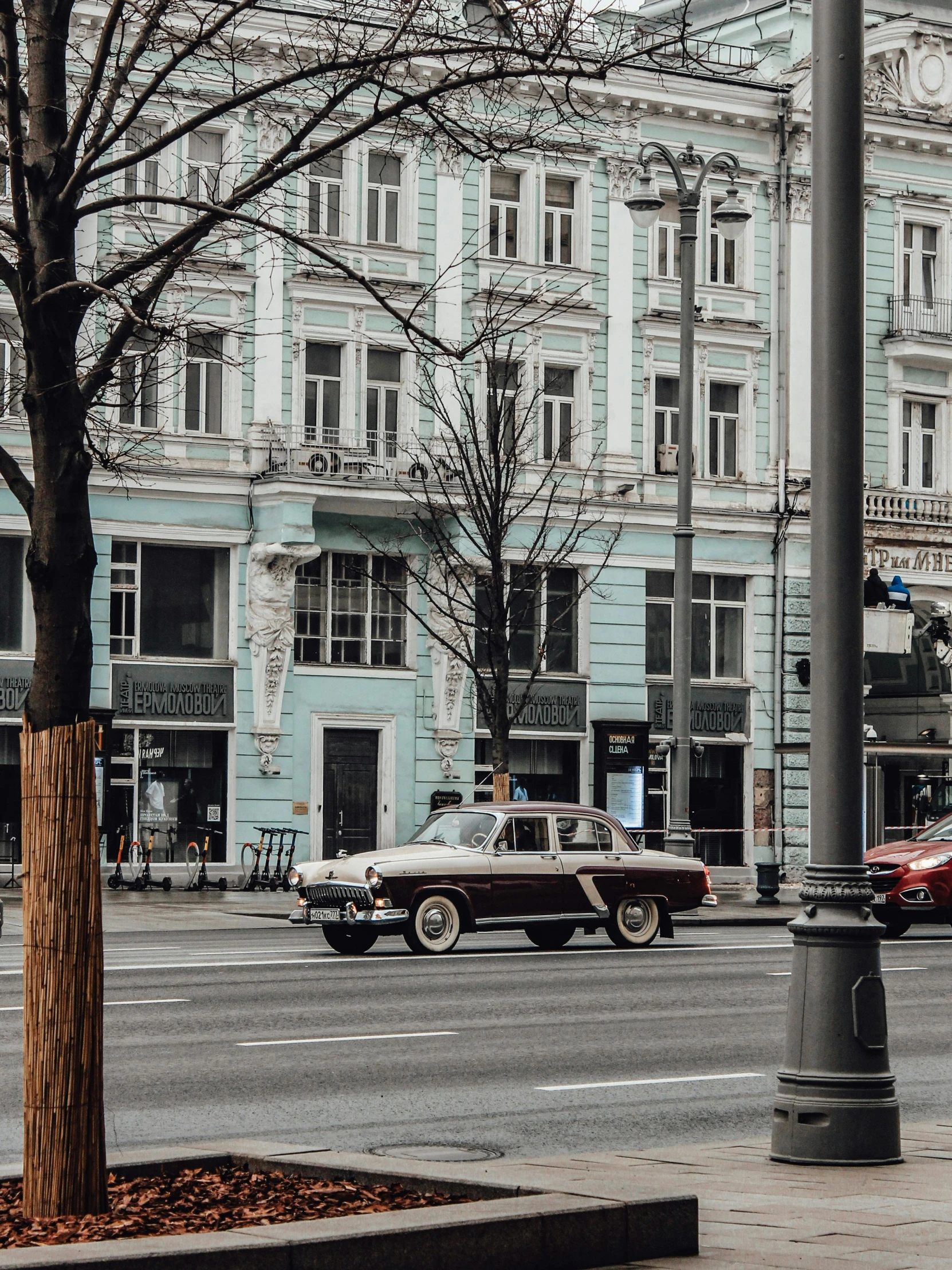 a red car in front of a street light