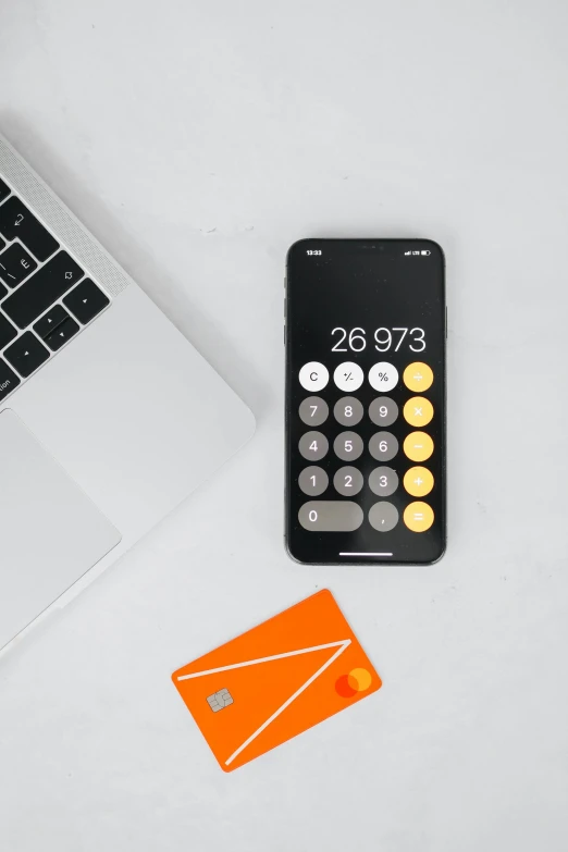 a calculator, keyboard and phone on a table