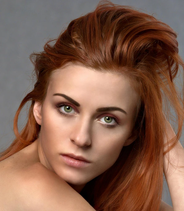 a beautiful woman with red hair posing for a portrait
