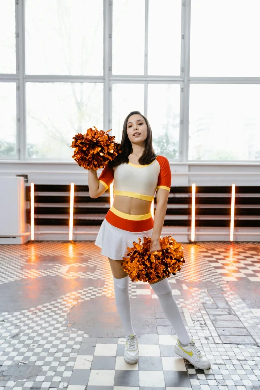a young woman wearing cheerleader outfits holding cheer pom poms