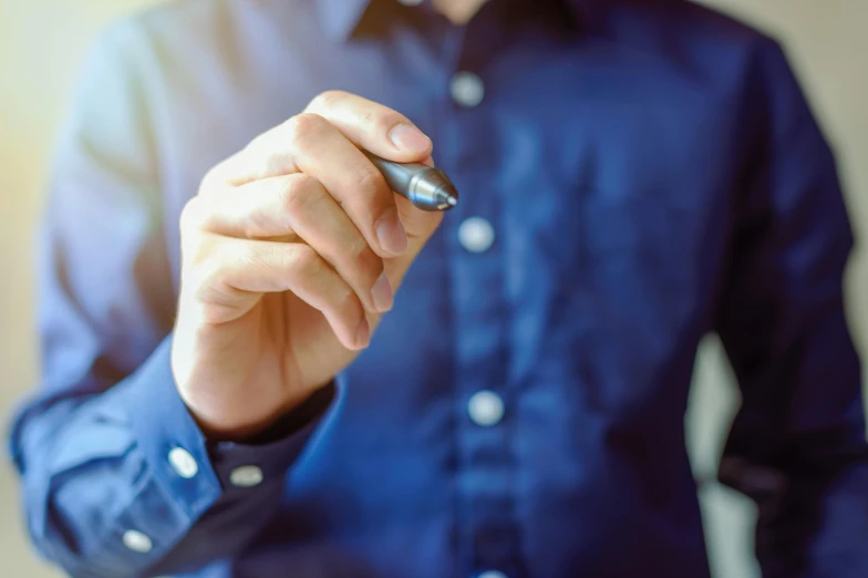 a man is writing with a marker in his left hand