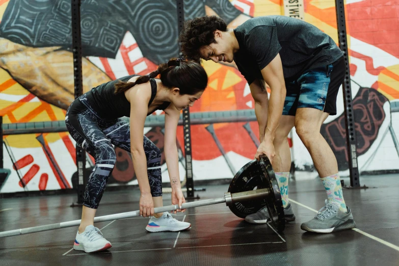 three people bent down and bending over with a basketball glove