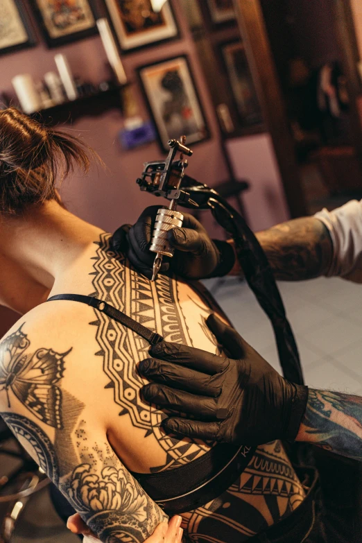 a tattooed woman getting her tattoo done