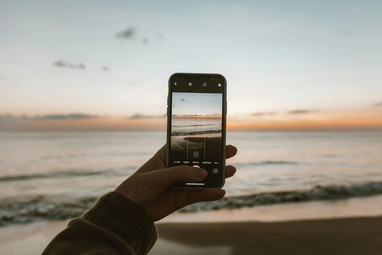 a person holding up their cell phone to take a picture