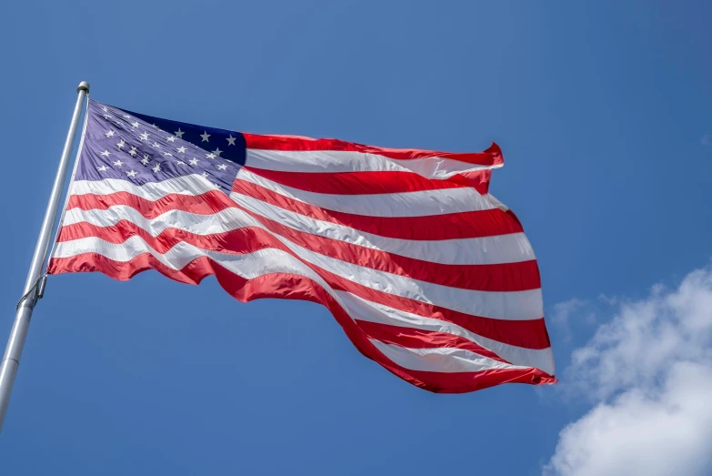 an american flag blowing in the wind