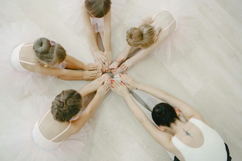 a group of dancers stretching out in a circle