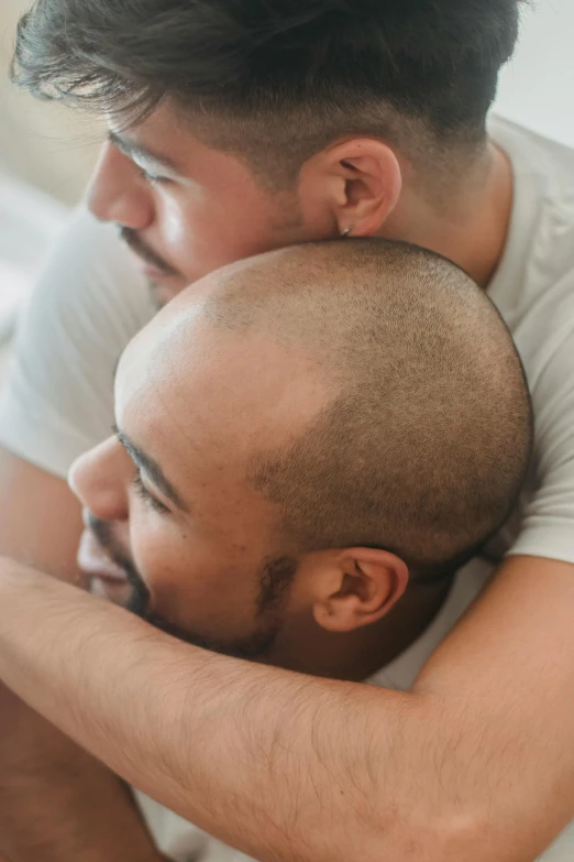 two men emcing each other with one looking away from the camera