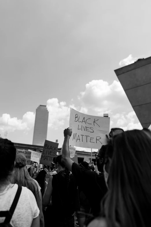 people holding up signs and protesting outside a building