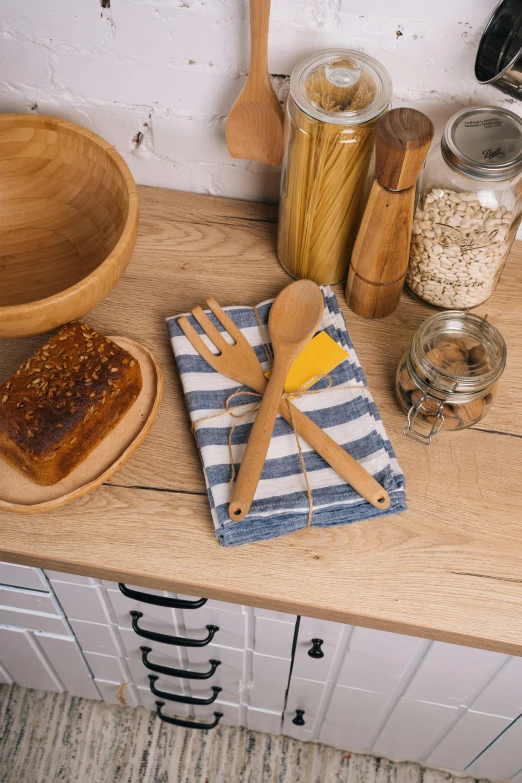 a close up of wooden spoons on top of a kitchen counter